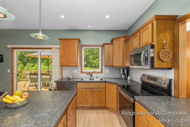 4349 Walter Rd, Wayland, MI 49348 - kitchen featuring stainless steel appliances, plenty of natural light, decorative backsplash, light wood finished floors, and recessed lighting