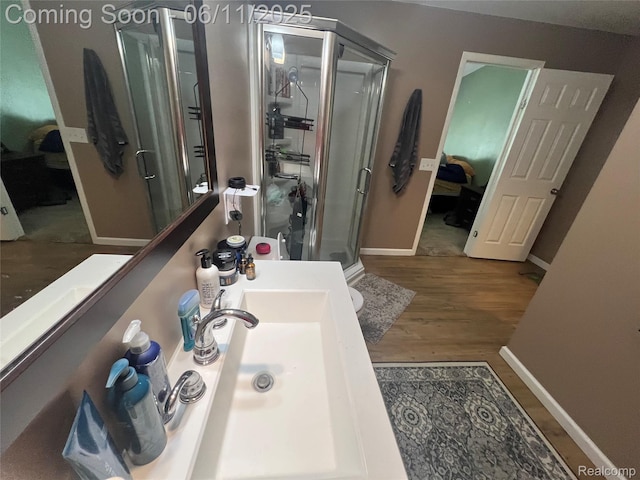 5550 Howe Rd, Grand Blanc, MI 48439 - full bathroom with ensuite bathroom, a shower stall, wood finished floors, and baseboards