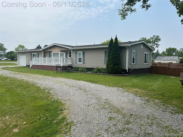 5550 Howe Rd, Grand Blanc, MI 48439 - view of front facade with a deck, driveway, and an attached garage
