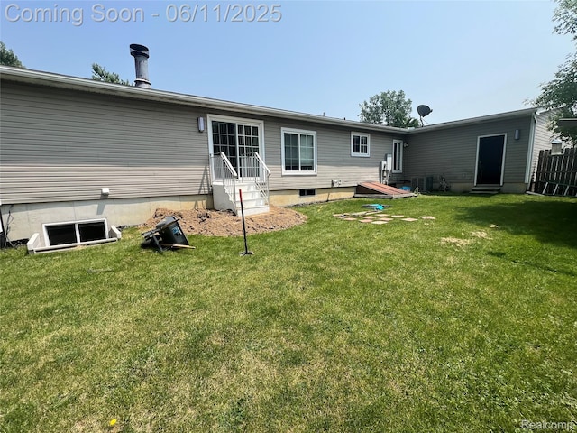 5550 Howe Rd, Grand Blanc, MI 48439 - back of property featuring a lawn