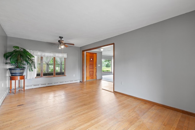 5244 Sand Creek Highway, Adrian, MI 49221 - empty room featuring a baseboard radiator, ceiling fan, plenty of natural light, and light wood-style floors