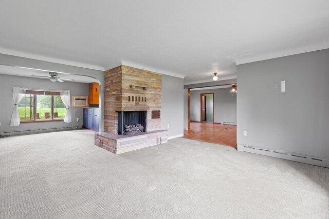 5244 Sand Creek Highway, Adrian, MI 49221 - unfurnished living room with a baseboard radiator, carpet flooring, a fireplace, and an AC wall unit
