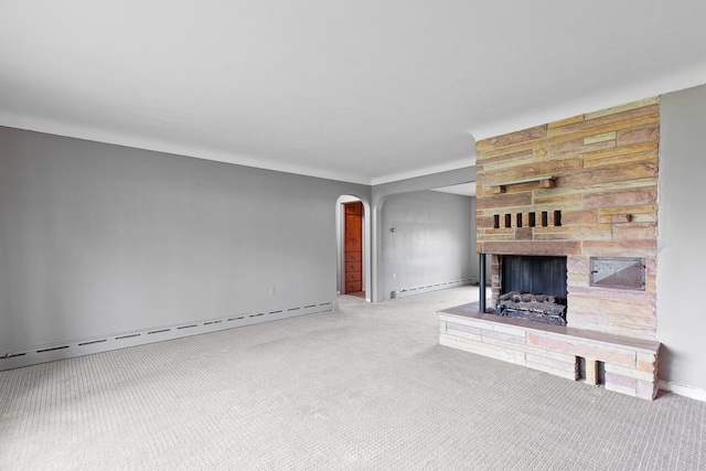 5244 Sand Creek Highway, Adrian, MI 49221 - unfurnished living room with arched walkways, a baseboard heating unit, carpet, and a fireplace