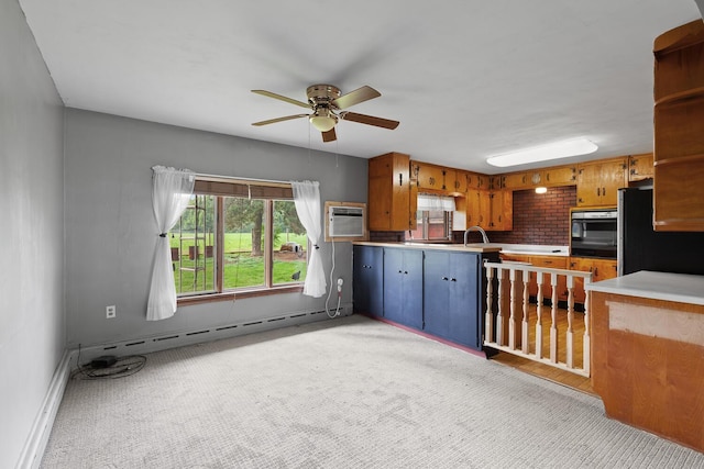 5244 Sand Creek Highway, Adrian, MI 49221 - kitchen featuring black appliances, a baseboard radiator, a ceiling fan, light colored carpet, and light countertops