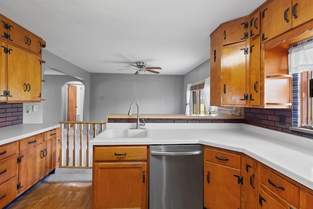5244 Sand Creek Highway, Adrian, MI 49221 - kitchen with dishwasher, a ceiling fan, a sink, light countertops, and backsplash