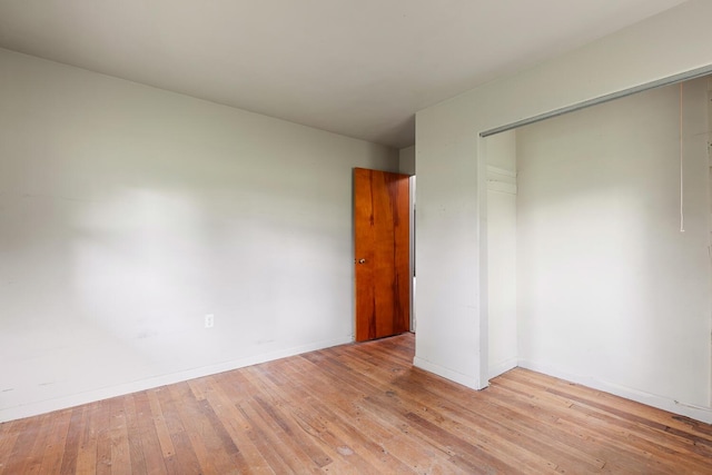 5244 Sand Creek Highway, Adrian, MI 49221 - unfurnished bedroom with a closet, light wood-style flooring, and baseboards