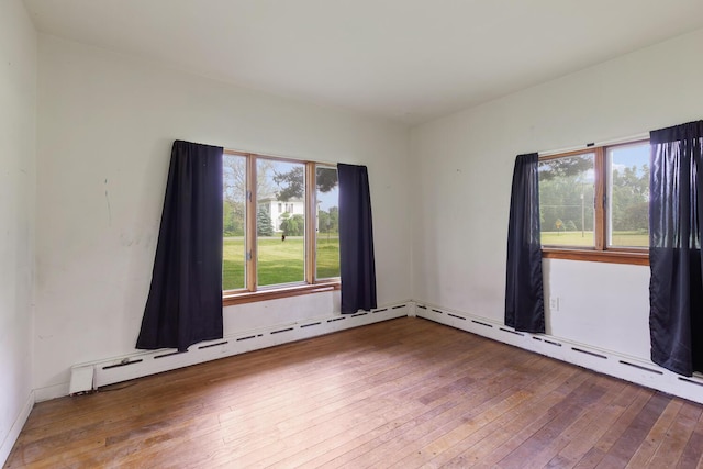 5244 Sand Creek Highway, Adrian, MI 49221 - unfurnished room featuring wood-type flooring and baseboard heating