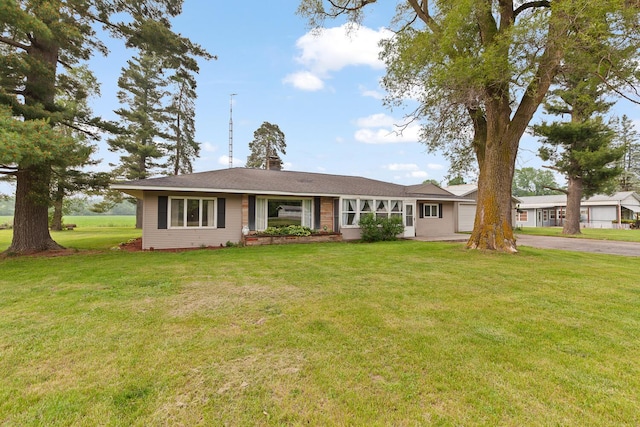 5244 Sand Creek Highway, Adrian, MI 49221 - ranch-style home featuring asphalt driveway, a garage, a front yard, and a chimney