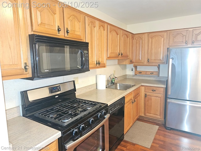 40859 Newport Dr, Plymouth, MI 48170 - kitchen featuring black appliances, a sink, light countertops, and dark wood-style flooring
