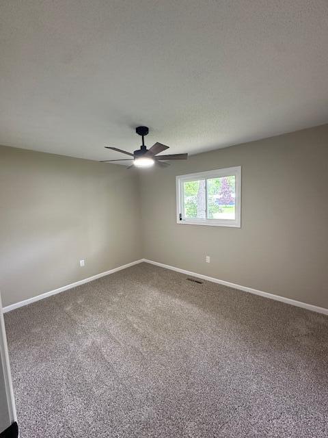 5511 Sunset Ct, Oscoda, MI 48750 - carpeted spare room featuring baseboards and a ceiling fan