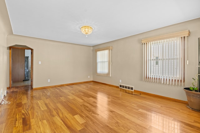 7369 Helen, Center Line, MI 48015 - unfurnished room featuring light wood-type flooring, arched walkways, and baseboards