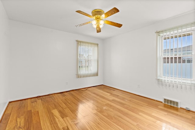 7369 Helen, Center Line, MI 48015 - empty room featuring plenty of natural light, ceiling fan, light wood-type flooring, and baseboards