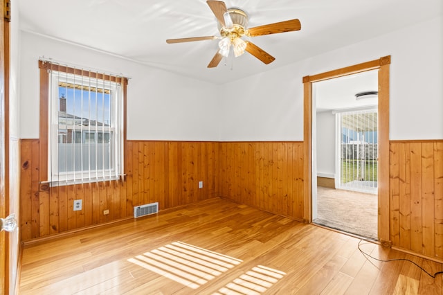 7369 Helen, Center Line, MI 48015 - unfurnished room featuring wainscoting, hardwood / wood-style floors, wood walls, and a ceiling fan
