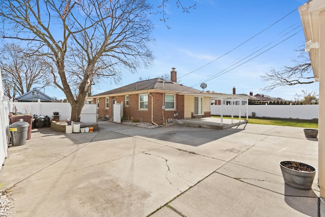 7369 Helen, Center Line, MI 48015 - rear view of property with brick siding, a patio, and a fenced backyard