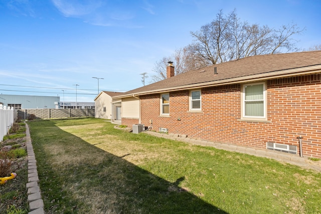 7369 Helen, Center Line, MI 48015 - rear view of house with brick siding, a chimney, central AC unit, and a shingled roof