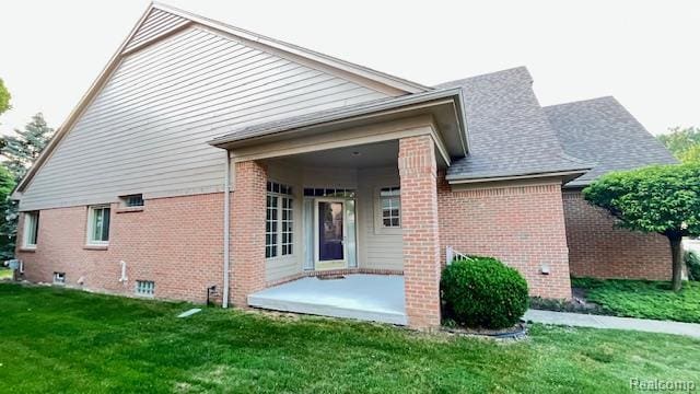 43573 E Perignon Dr N, Sterling Heights, MI 48314 - rear view of house with brick siding, a patio area, and a yard