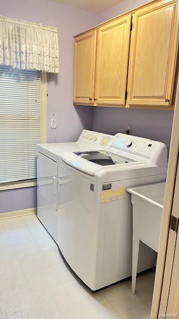 43573 E Perignon Dr N, Sterling Heights, MI 48314 - washroom featuring washer and dryer, cabinet space, light floors, and baseboards