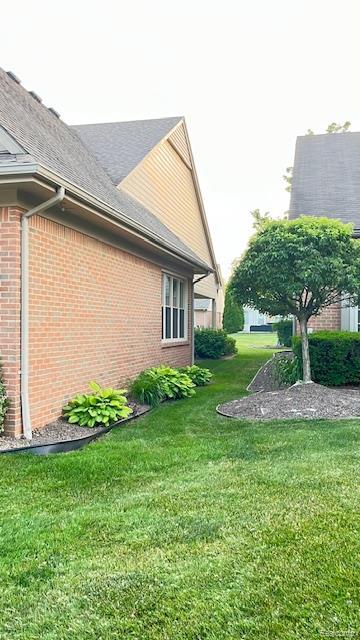 43573 E Perignon Dr N, Sterling Heights, MI 48314 - view of property exterior featuring brick siding and a lawn