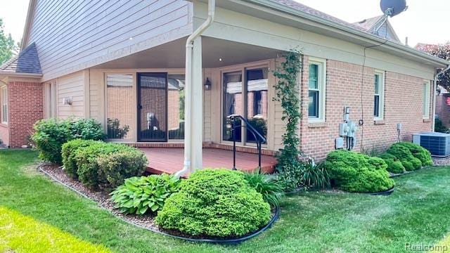43573 E Perignon Dr N, Sterling Heights, MI 48314 - rear view of property with brick siding, cooling unit, and a yard