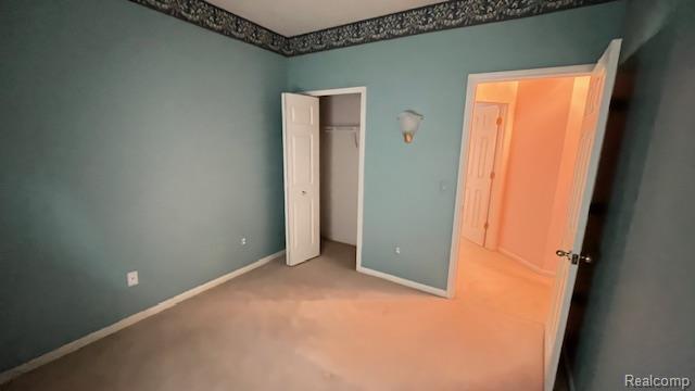 43573 E Perignon Dr N, Sterling Heights, MI 48314 - unfurnished bedroom featuring carpet floors, baseboards, and a closet
