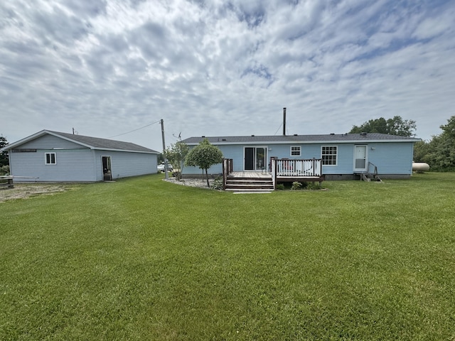 3828 90th Ave, Evart, MI 49631 - back of property featuring a lawn and a deck