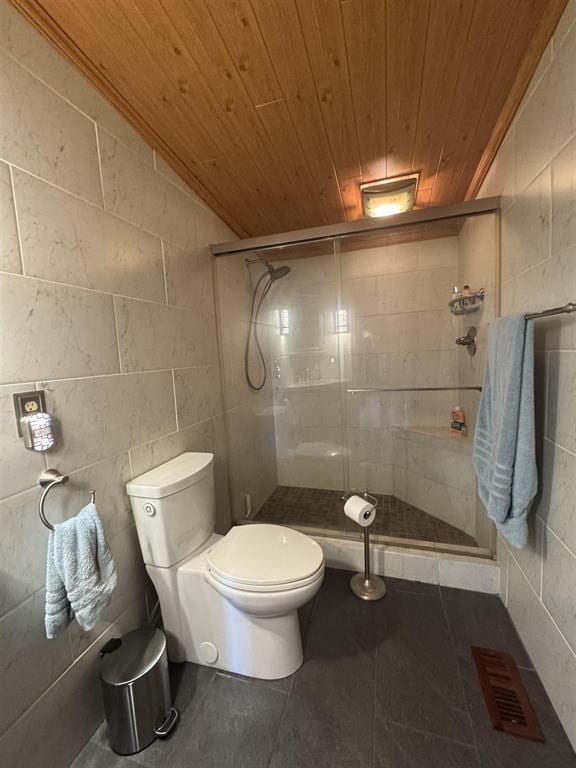 3828 90th Ave, Evart, MI 49631 - full bath with wooden ceiling, a shower stall, tile patterned floors, toilet, and tile walls