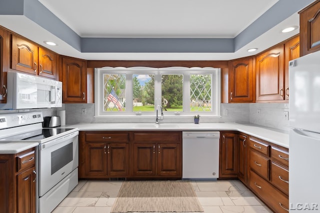 603 Outer Dr, Tecumseh, MI 49286 - kitchen with white appliances, a sink, light marble finish floors, crown molding, and healthy amount of natural light