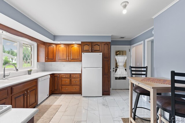 603 Outer Dr, Tecumseh, MI 49286 - kitchen featuring white appliances, a sink, light marble finish flooring, light countertops, and crown molding