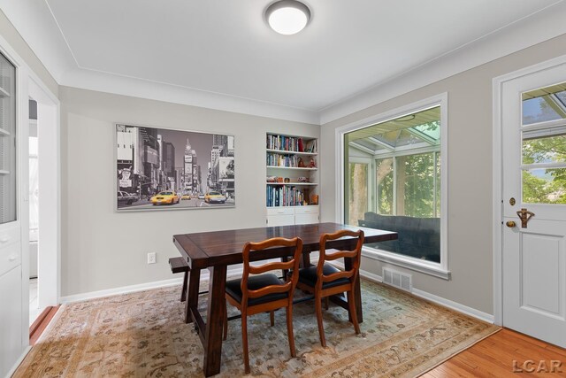 603 Outer Dr, Tecumseh, MI 49286 - dining area featuring wood finished floors, baseboards, and built in features