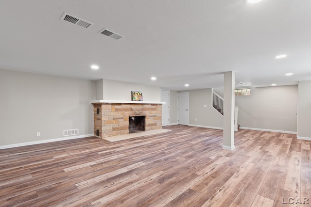 603 Outer Dr, Tecumseh, MI 49286 - finished below grade area featuring stairs, wood finished floors, baseboards, a fireplace, and recessed lighting