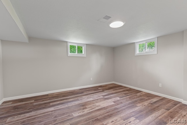 603 Outer Dr, Tecumseh, MI 49286 - basement featuring wood finished floors, healthy amount of natural light, and baseboards