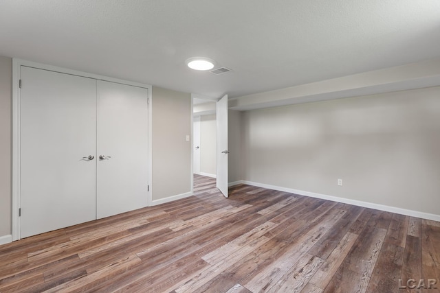 603 Outer Dr, Tecumseh, MI 49286 - unfurnished bedroom featuring wood finished floors, baseboards, and a closet