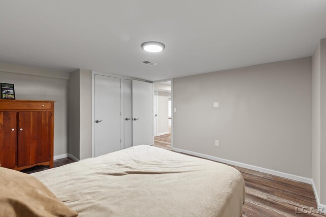 603 Outer Dr, Tecumseh, MI 49286 - bedroom with baseboards and wood finished floors