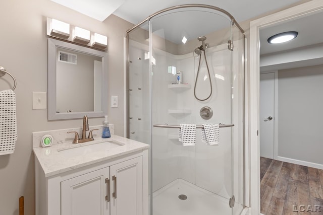 603 Outer Dr, Tecumseh, MI 49286 - full bath with a shower stall, vanity, and wood finished floors