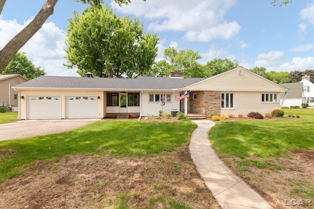 603 Outer Dr, Tecumseh, MI 49286 - single story home featuring a garage, a front lawn, a chimney, driveway, and central AC
