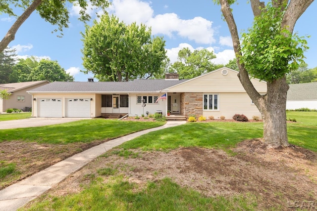 603 Outer Dr, Tecumseh, MI 49286 - ranch-style home with a garage, driveway, a chimney, and a front yard