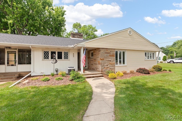 603 Outer Dr, Tecumseh, MI 49286 - single story home with a chimney, a front lawn, a sunroom, and a shingled roof