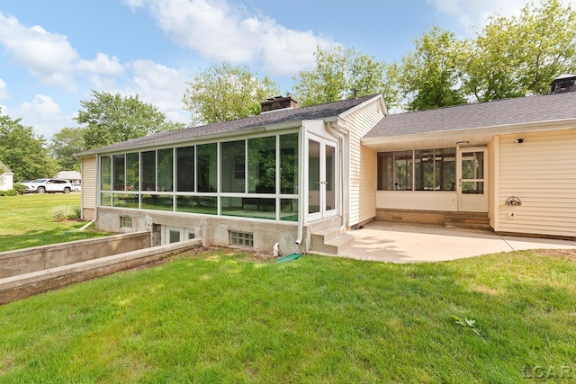 603 Outer Dr, Tecumseh, MI 49286 - back of property featuring a sunroom, a lawn, a chimney, and a patio