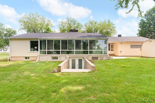 603 Outer Dr, Tecumseh, MI 49286 - rear view of house with a sunroom, french doors, a yard, and a chimney