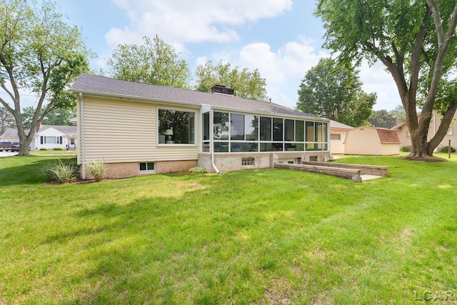 603 Outer Dr, Tecumseh, MI 49286 - rear view of house with a yard, a chimney, and a sunroom