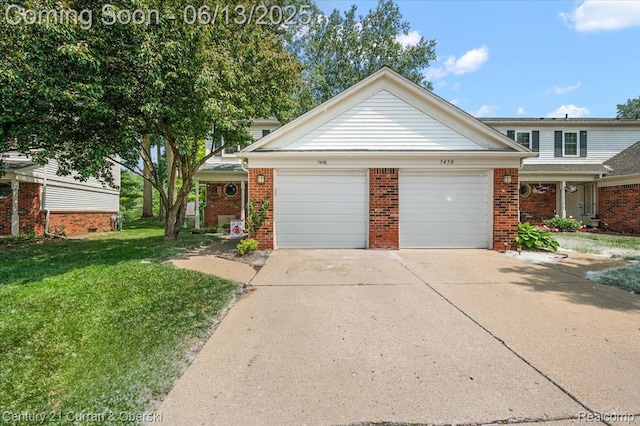 7456 N Kingston Ct, Westland, MI 48185 - view of front of house with a garage, brick siding, a front yard, and driveway