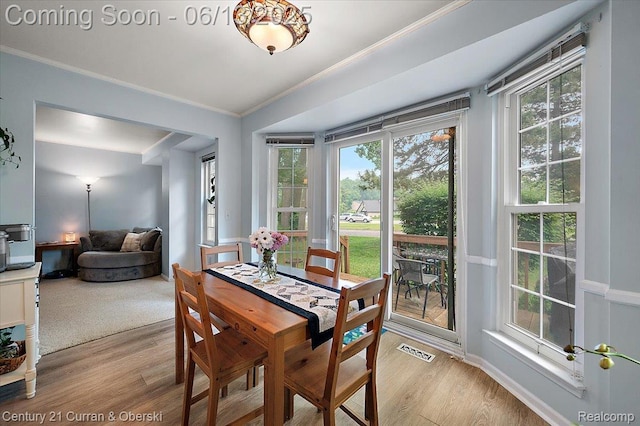7456 N Kingston Ct, Westland, MI 48185 - dining area with light wood-style floors, crown molding, and plenty of natural light