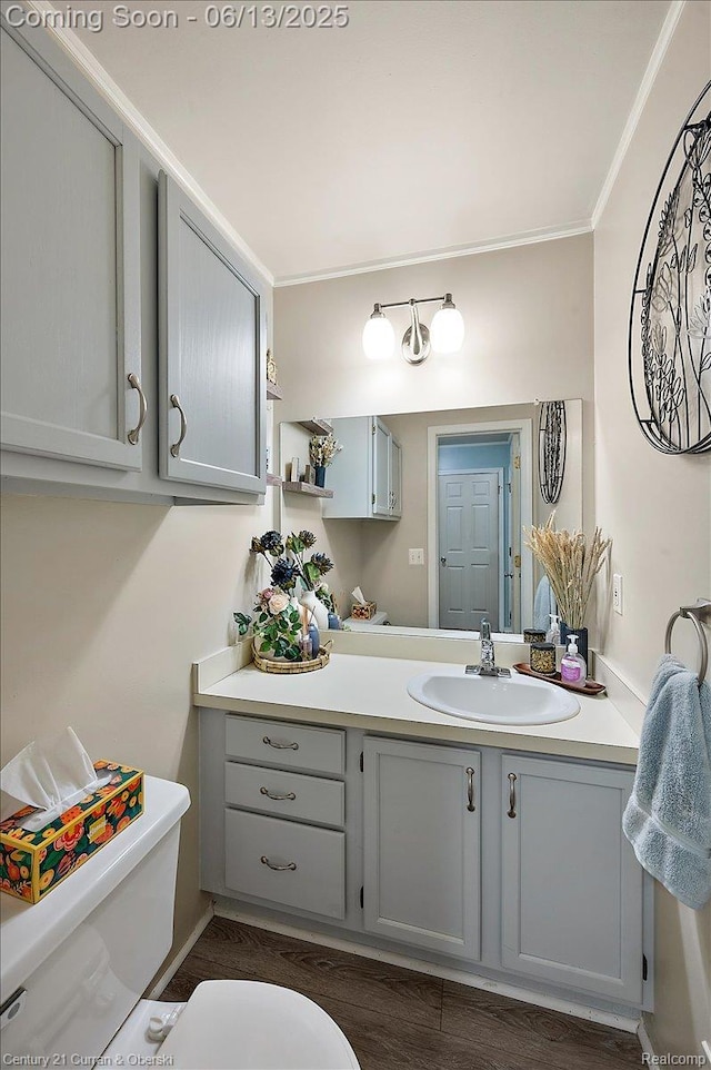 7456 N Kingston Ct, Westland, MI 48185 - half bathroom with ornamental molding, vanity, and wood finished floors