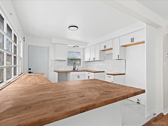 19468 Evergreen Rd, Detroit, MI 48219 - kitchen with white cabinetry, backsplash, and butcher block countertops
