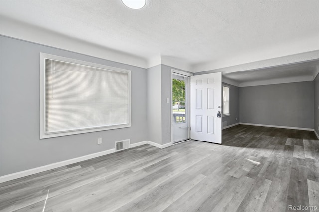 5932 Colorado St, Romulus, MI 48174 - foyer entrance featuring wood finished floors, baseboards, and a textured ceiling