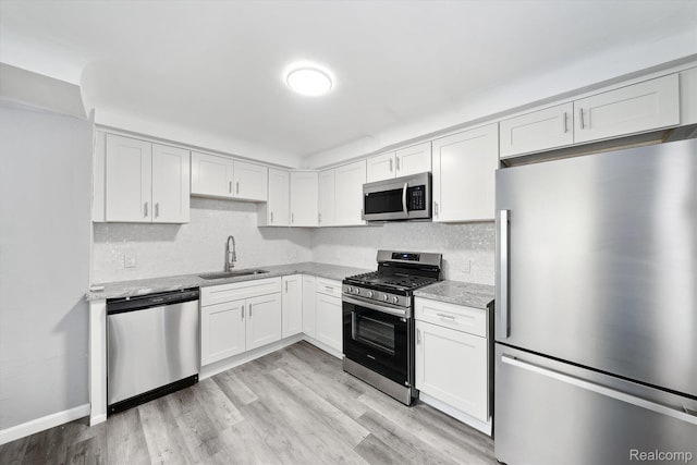 5932 Colorado St, Romulus, MI 48174 - kitchen with stainless steel appliances, a sink, light stone countertops, and backsplash
