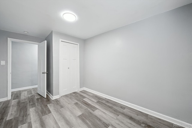 5932 Colorado St, Romulus, MI 48174 - unfurnished bedroom featuring wood finished floors, baseboards, and a closet