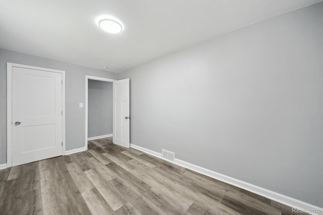 5932 Colorado St, Romulus, MI 48174 - unfurnished bedroom with wood finished floors and baseboards