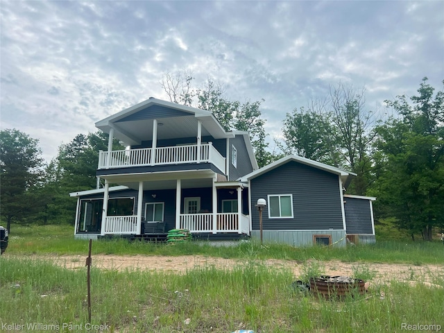11755 Jakob Ln, Lachine, MI 49753 - view of front of house with a porch and a balcony