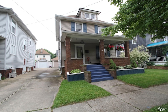633 Scott St, Monroe, MI 48161 - american foursquare style home with covered porch, an outdoor structure, brick siding, a detached garage, and driveway